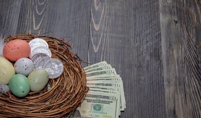 Nest with eggs, silver coins and bills, investment concept.