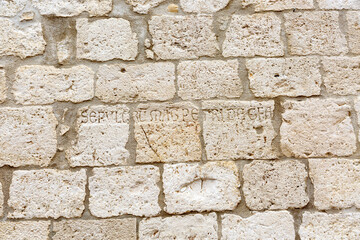 Text on wall near  basilica San Nicola in Bari