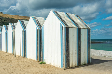 Obraz na płótnie Canvas Famous white and blue beach huts in Yport, Normandy, France