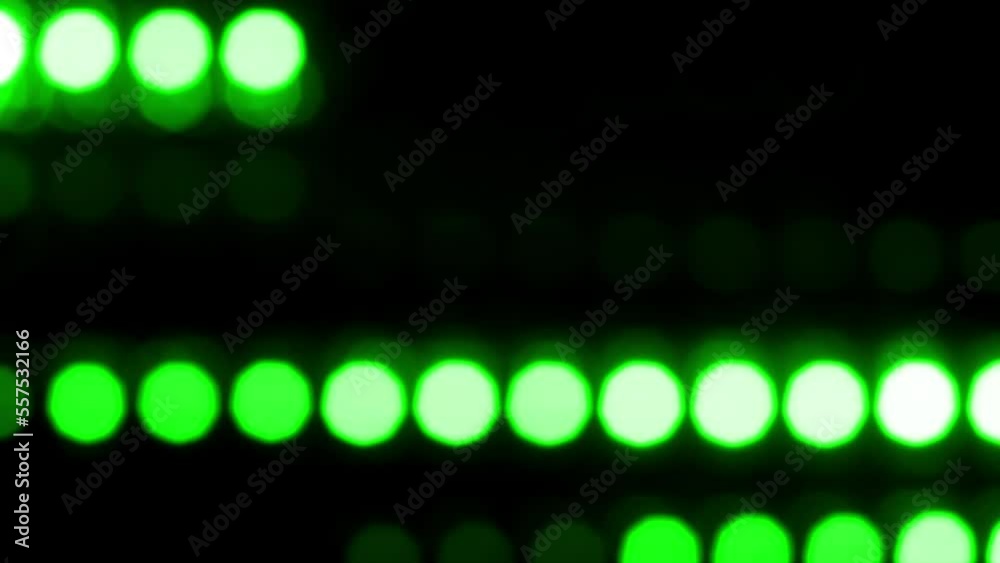 Wall mural lines of round green bokeh move horizontally. abstract moving background with natural lens flare eff