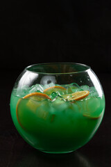 Glass of cocktail green fairy with lemon and absinthe at bar