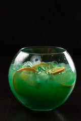 Glass of cocktail green fairy with lemon and absinthe at bar