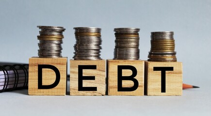 DEBT word on wooden block, concept of business and bankrupt