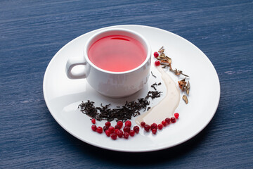 Cup of healthy traditional herbal rooibos red beverage tea on wooden table