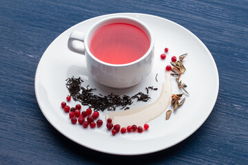 Cup of healthy traditional herbal rooibos red beverage tea on wooden table