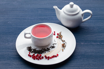 Cup of healthy traditional herbal rooibos red beverage tea on wooden table