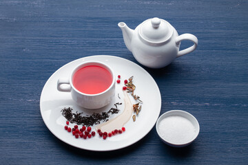 Cup of healthy traditional herbal rooibos red beverage tea on wooden table
