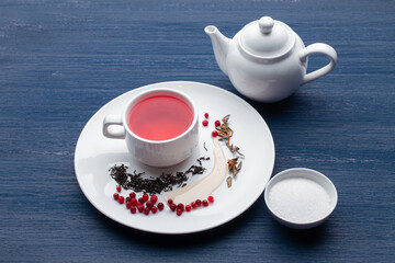 Cup of healthy traditional herbal rooibos red beverage tea on wooden table