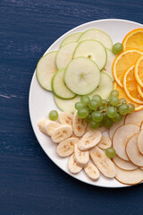 Assortment of tropical fruits on a white plate