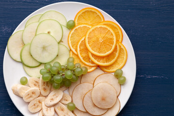 Assortment of tropical fruits on a white plate