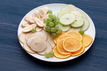 Assortment of tropical fruits on a white plate