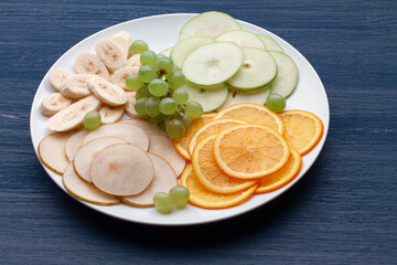 Assortment of tropical fruits on a white plate
