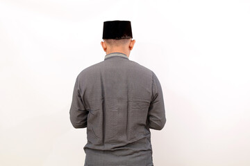 Obraz na płótnie Canvas Back view of asian muslim man standing with muslim costume. Isolated on white background
