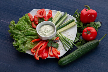 Platter of assorted fresh vegetables with dip
