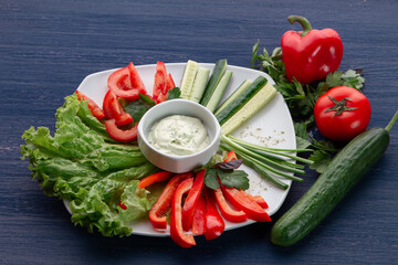 Platter of assorted fresh vegetables with dip