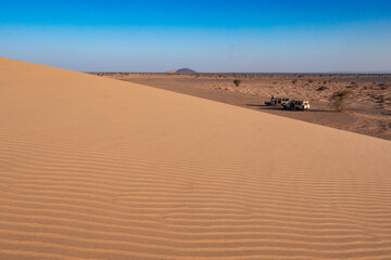 Fototapeta na wymiar Scenic view of tourist safari jeeps seen from North Sand Dune in Marsabit, Kenya