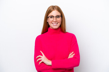 Young redhead woman isolated on white background keeping the arms crossed in frontal position
