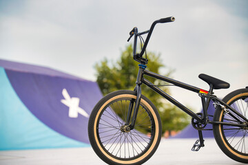 Fototapeta premium bicycle on the park space, exhilaration, park, racey, motion, adventure, ramp high, flight, black, concrete, fly, pursuit, culture, flying, recreational fast