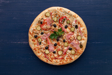 Delicious pizza with olives and sausages on wooden table