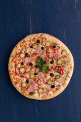 Delicious pizza with olives and sausages on wooden table