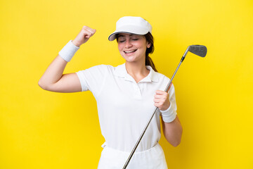 young caucasian woman playing golf isolated on yellow background doing strong gesture