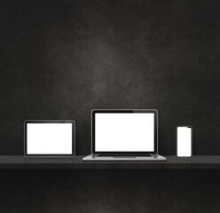 Laptop, mobile phone and digital tablet pc on black wall shelf. Square background