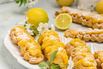 French dessert eclairs with lemon curd. Food recipe background. Close up