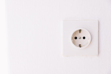 Power socket on the empty white wall