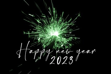 Happy new year 2023 green sparkler new years eve countdown. Luxury entertainment celebration turn of the year party time. Premium nightlife visual with glowing light sparks on dark background - 557550545