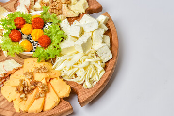 Assorted cheese mixed set on wood plate with copy space.