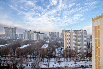 Residential area of Moscow on winter evening, against a beautiful sky with clouds, Russia