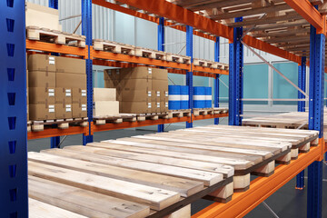 Boxes in stock. Pallets on storage racks. Warehouse furniture closeup. Industrial furniture for...