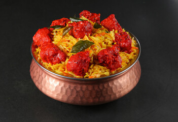 Chicken 65 Biryani bronze bowl black background 