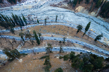 Aerial drone shot showing cars lined up in traffic jam on the winding road to Atal Tunnel from...