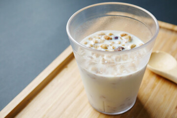 breakfast cereal and mixed with milk in a glass on table 