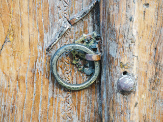 Beautiful, vintage door with a metal handle. Close-up, outdoors. Day light. Vacation and travel concept