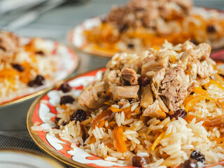 Plates with fragrant pilaf are on the table. Close-up, indoors, directly above . Tasty and healthy food concept