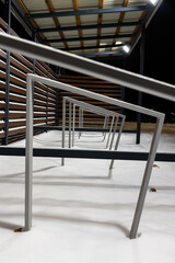 Obraz premium Empty shed with bicycle racks in a city park in winter. Difficulties in traveling by bike in winter.