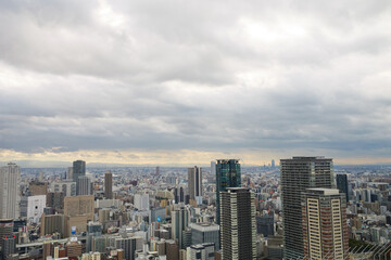 Fototapeta na wymiar Overhead view of Osaka's Umeda area from a hill on a cloudy day