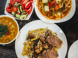 Plates with fragrant pilaf are on the table. Close-up, indoors, directly above . Tasty and healthy food concept