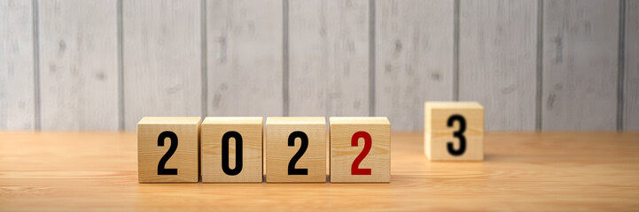 cubes with message 2022 - 2023 on wooden background