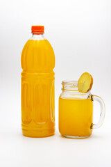 Glass of orange juice and orange juice bottles isolated on white background