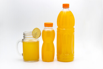 Glass of orange juice and orange juice bottles isolated on white background
