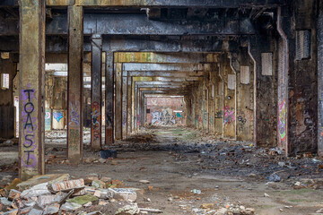 Messy abandoned factory warehouse. Creepy industrial hall