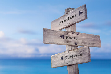 prefixes roots suffixes text quote on wooden signpost crossroad by the sea - obrazy, fototapety, plakaty