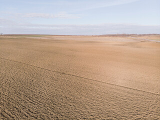 Large agricultural plowed fields. Drone point of view.