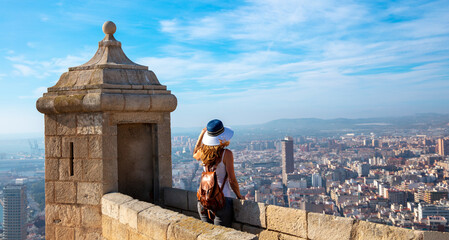 Traveler woman looking at panoramic spanish city landscape from Santa Barbara castle- Alicante - obrazy, fototapety, plakaty