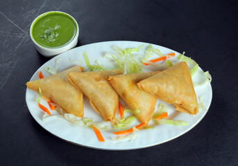 Pakistani Indian samosa Starter Appetizer black background 