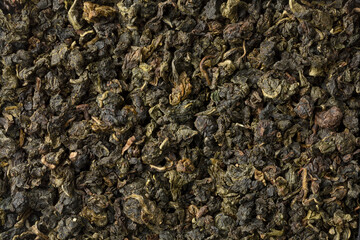 Chinese Ti Kuan Yin dried tea leaves full frame close up as background