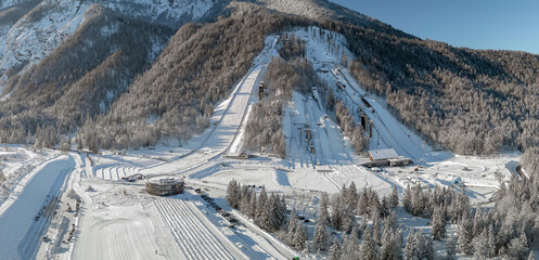 Ski Jump in Planica near Kranjska Gora Slovenia covered in snow at winter time. Aerial Panorama - obrazy, fototapety, plakaty